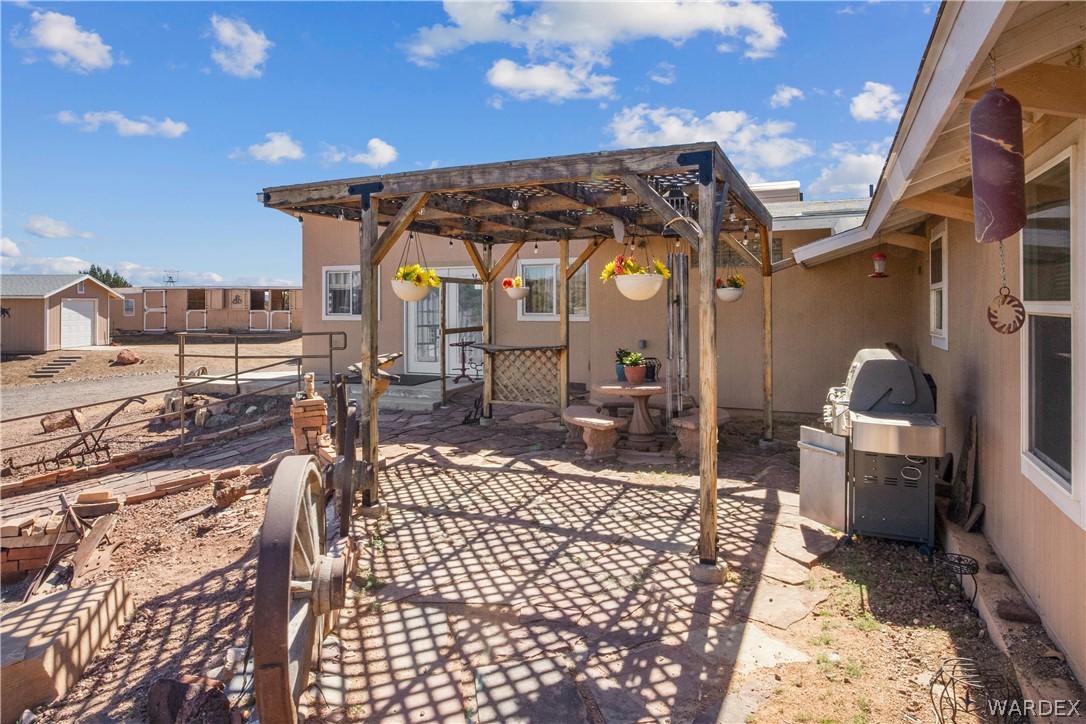1108 South McCarrel Road Kingman, AZ 86401 - Photo 23 of 65 View of patio with grilling area and a pergola