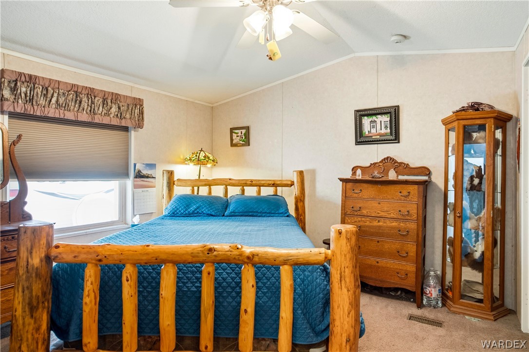 1108 South McCarrel Road Kingman, AZ 86401 - Photo 33 of 65 a bedroom with furniture and wooden floor