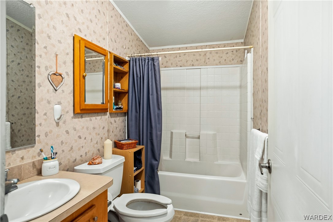 1108 South McCarrel Road Kingman, AZ 86401 - Photo 35 of 65 a bathroom with a sink toilet and shower