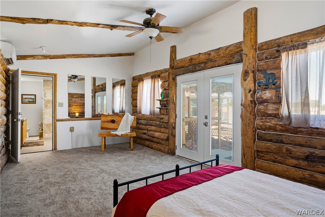 1108 South McCarrel Road Kingman, AZ 86401 - Photo 41 of 65 a bedroom with a bed and wooden floor