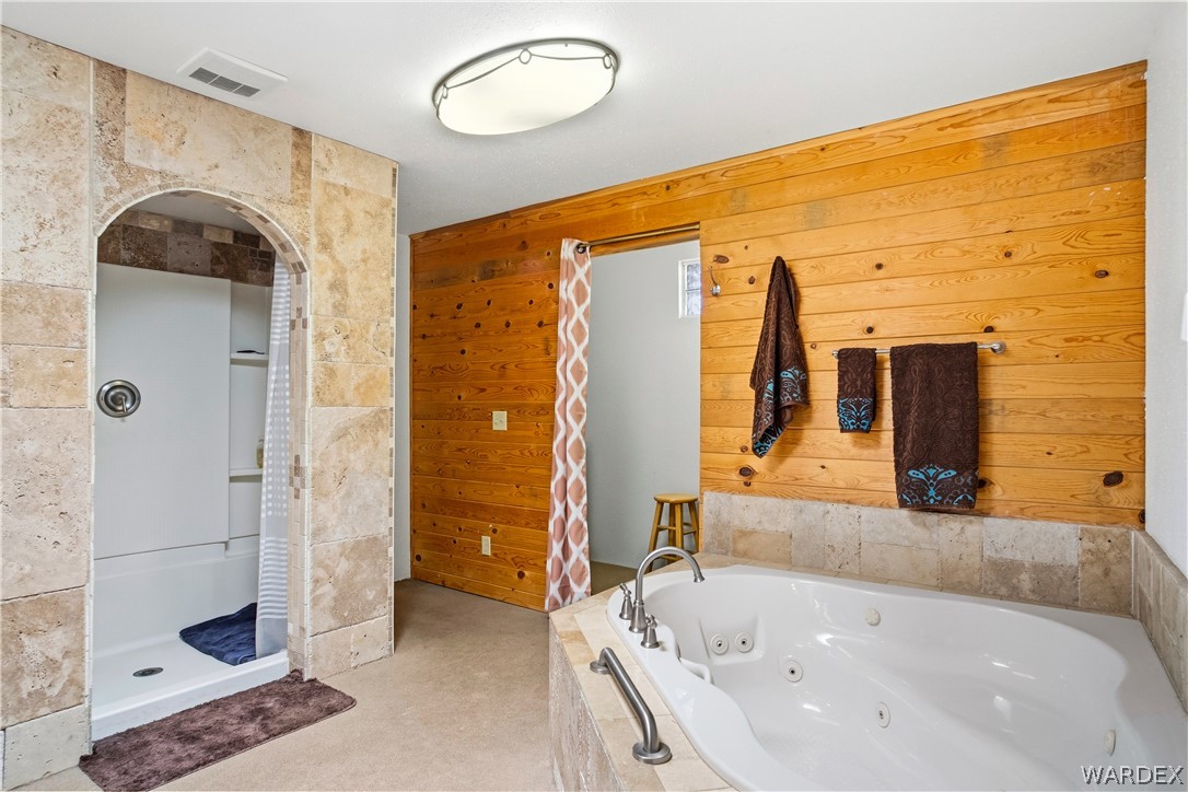 1108 South McCarrel Road Kingman, AZ 86401 - Photo 42 of 65 a bathroom with a bathtub and a shower