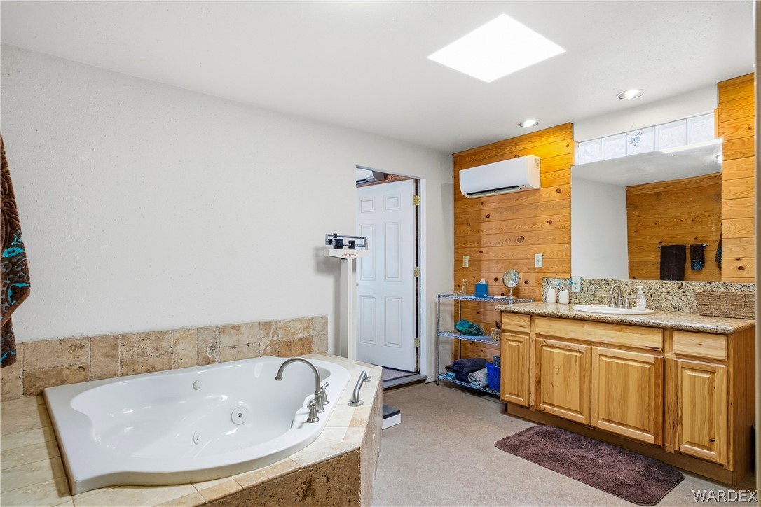 1108 South McCarrel Road Kingman, AZ 86401 - Photo 44 of 65 a bathroom with a tub sink and mirror