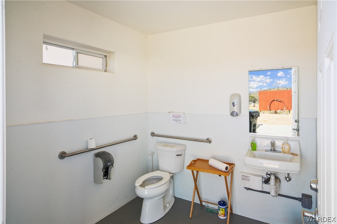 1108 South McCarrel Road Kingman, AZ 86401 - Photo 48 of 65 a white toilet sitting next to a bathroom sink