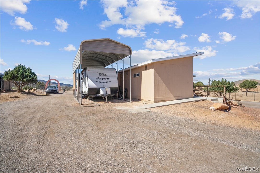 1108 South McCarrel Road Kingman, AZ 86401 - Photo 65 of 65 View of outdoor structure with a carport and dirt driveway