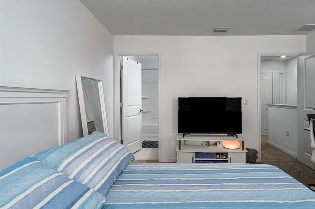 a living room with flat screen tv and a fireplace