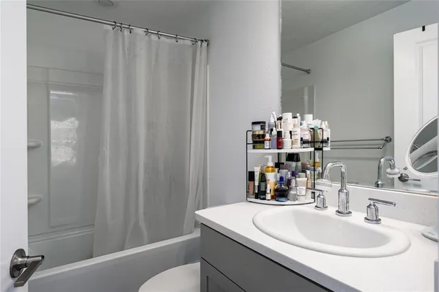 a bathroom with a sink vanity and a mirror