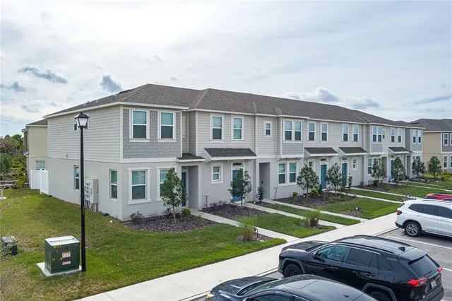 a view of a house with a swimming pool and a yard