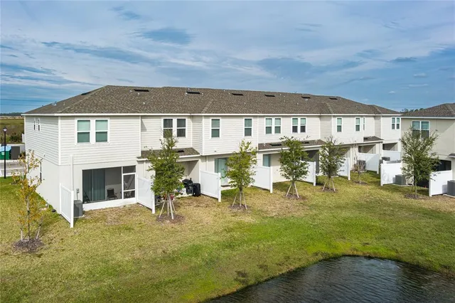 a view of a patio with table and chairs with wooden floor and fence