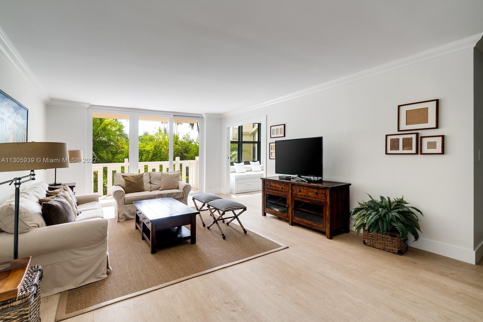 1121 Crandon Boulevard, Unit D206 Key Biscayne, FL 33149 - Photo 3 of 22 a living room with furniture and a flat screen tv