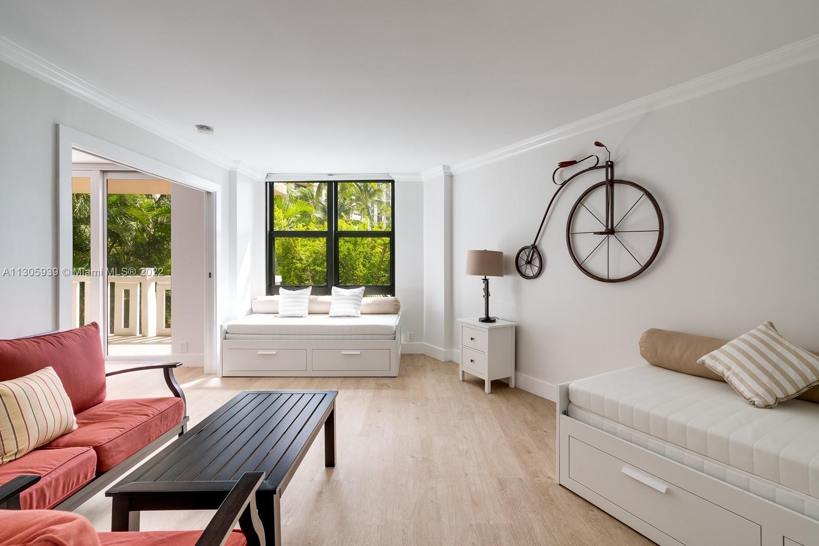 1121 Crandon Boulevard, Unit D206 Key Biscayne, FL 33149 - Photo 7 of 22 a living room with furniture a bed and a large window