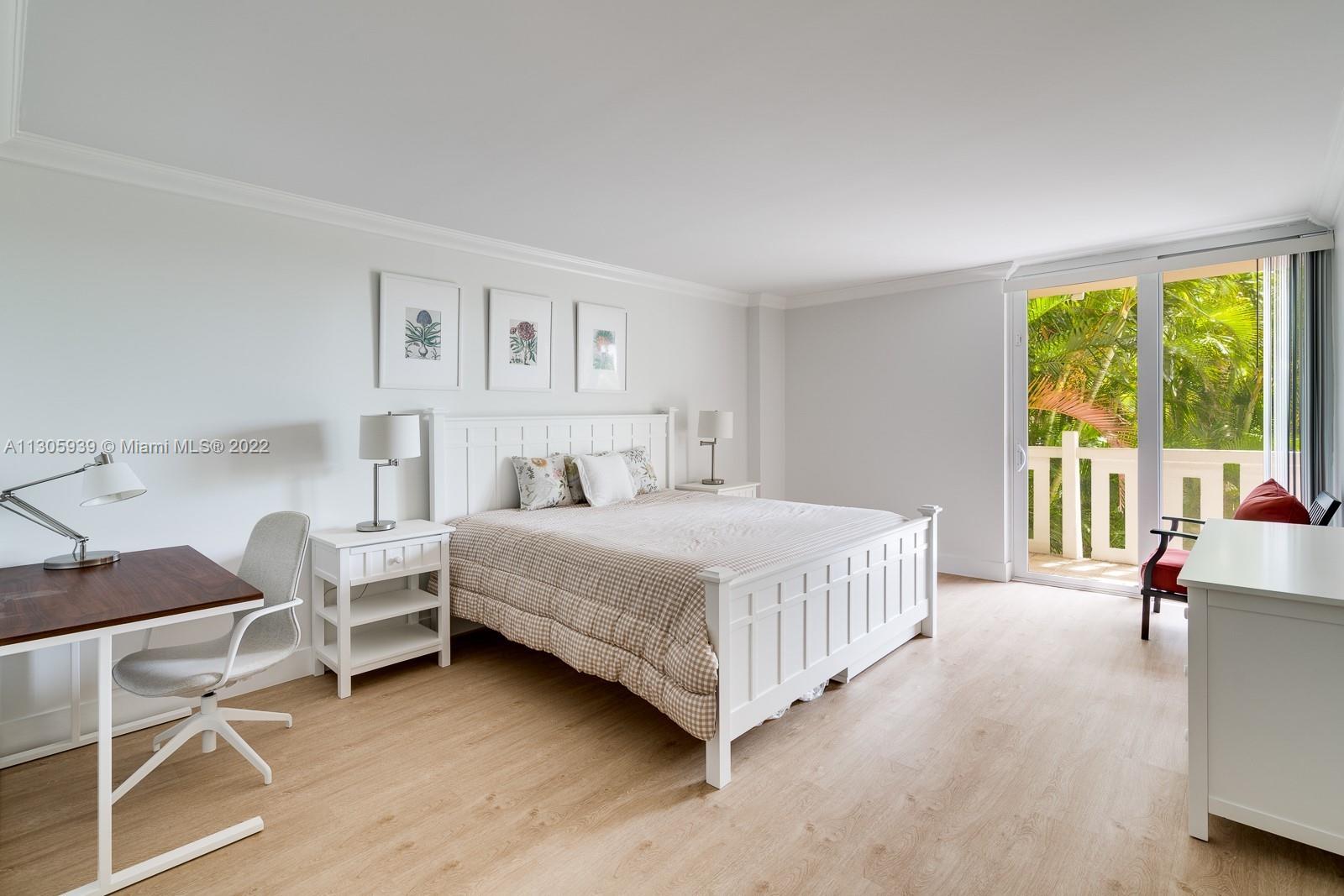 1121 Crandon Boulevard, Unit D206 Key Biscayne, FL 33149 - Photo 8 of 22 a bedroom with a bed chair and a large window