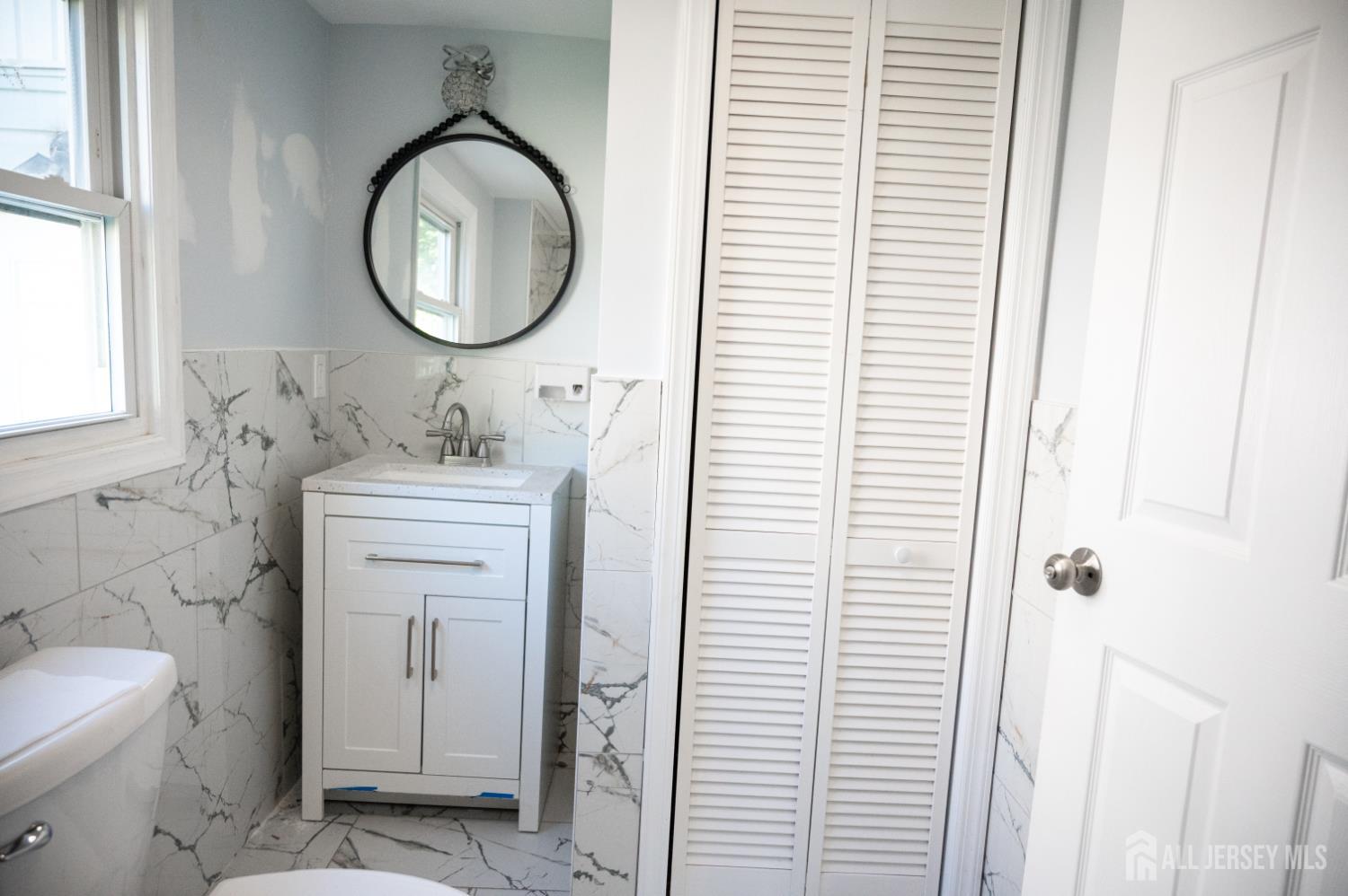101 Perry Street Keyport, NJ 07735 - Photo 12 of 15 a bathroom with a toilet a sink and a mirror