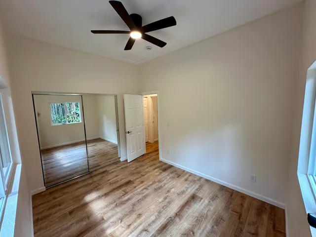 wooden floor in an empty room with a window