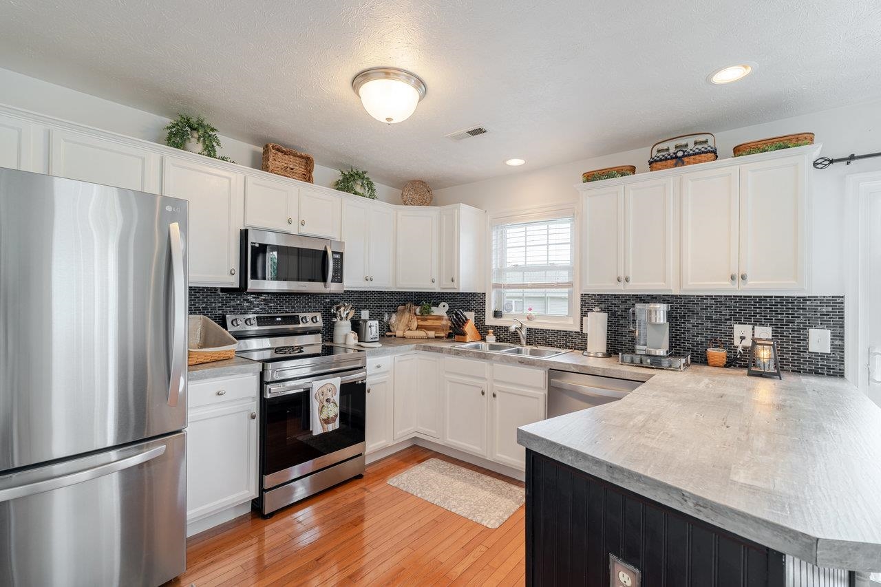 3035 Taylor Spring Lane Harrisonburg, VA 22801 - Photo 11 of 55 a kitchen with white cabinets and stainless steel appliances