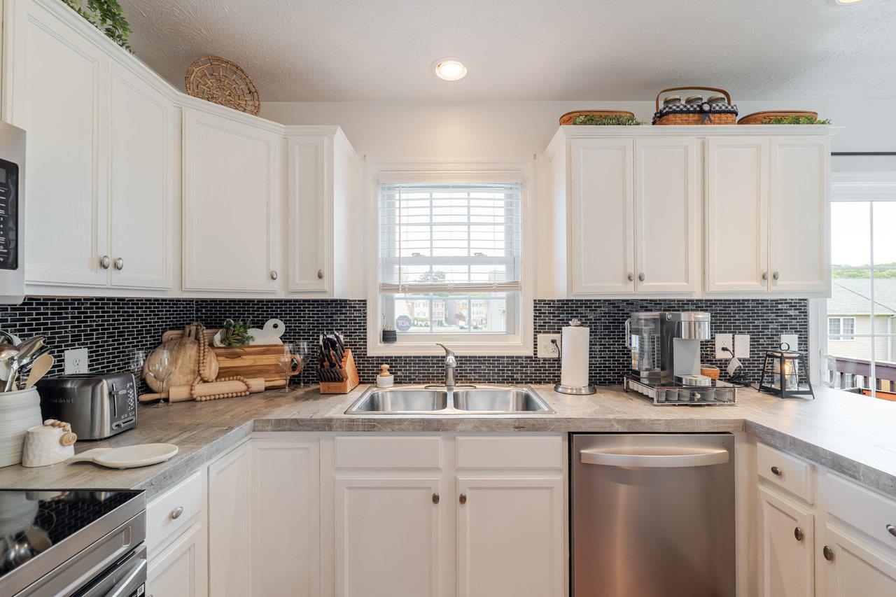 3035 Taylor Spring Lane Harrisonburg, VA 22801 - Photo 12 of 55 a kitchen with stainless steel appliances granite countertop a sink a stove and white cabinets