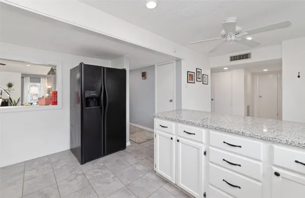 a kitchen with stainless steel appliances a refrigerator sink and microwave