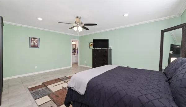 a bedroom with a bed a book shelf and a window