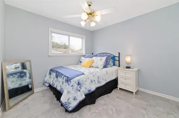 a bathroom with a granite countertop sink a toilet and mirror