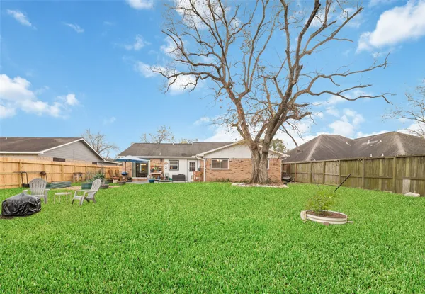 a view of a house with backyard porch and sitting area