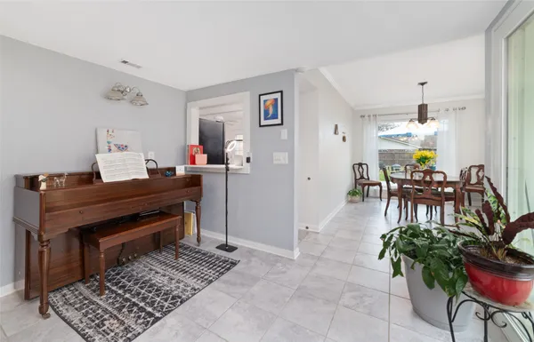 a living room with furniture a flat screen tv and a view of kitchen