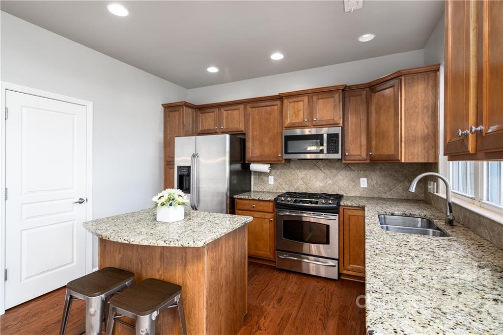 669 6th Baxter Crossing Fort Mill, SC 29708 - Photo 12 of 39 a kitchen with a stove a sink and a microwave