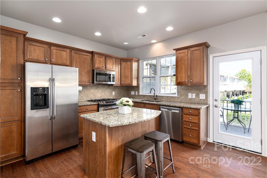 669 6th Baxter Crossing Fort Mill, SC 29708 - Photo 13 of 39 a kitchen with a refrigerator a sink a stove a microwave a counter top space and cabinets