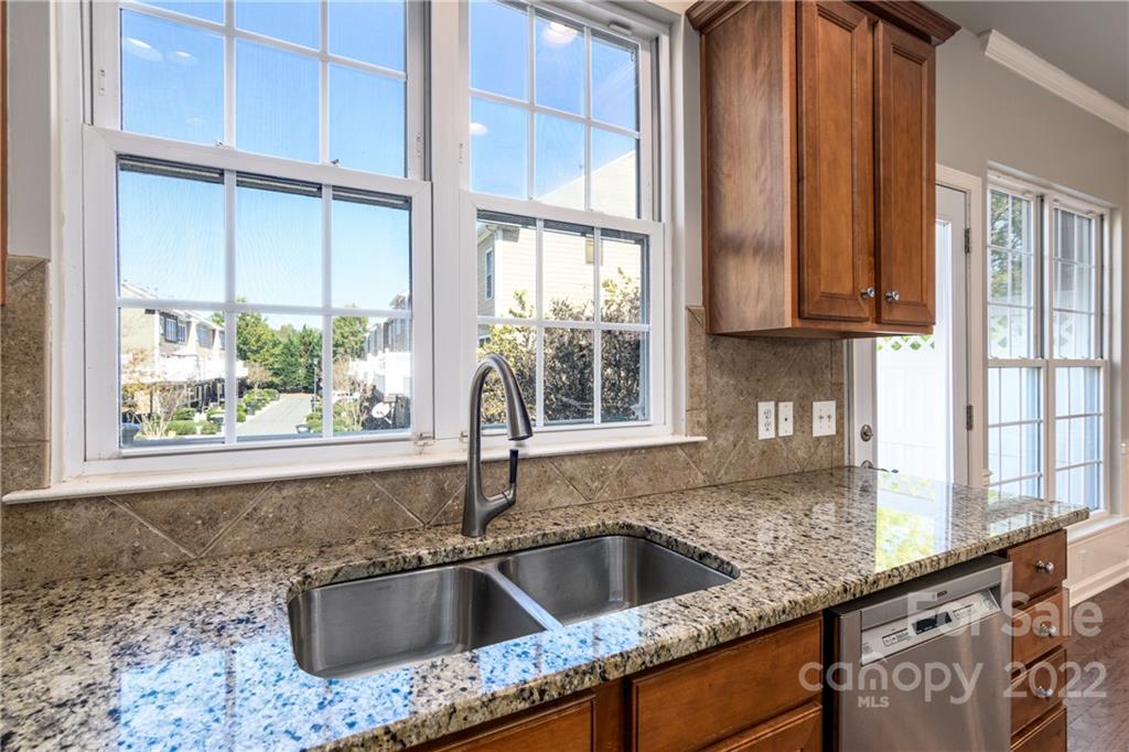 669 6th Baxter Crossing Fort Mill, SC 29708 - Photo 14 of 39 a kitchen with granite countertop a sink and a window