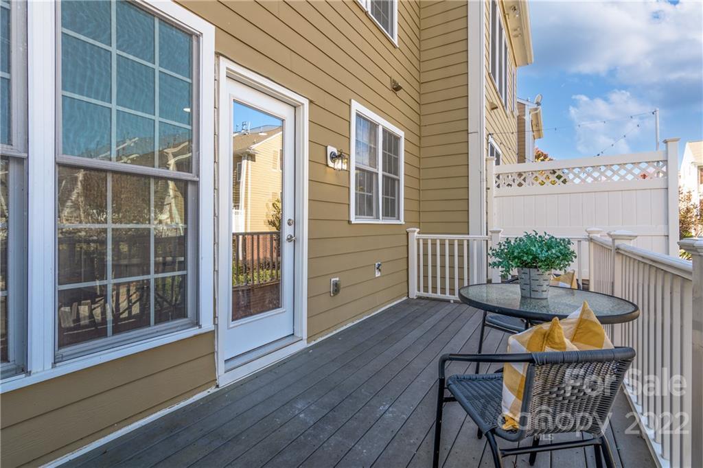 669 6th Baxter Crossing Fort Mill, SC 29708 - Photo 17 of 39 a view of a deck with table and chairs and wooden floor