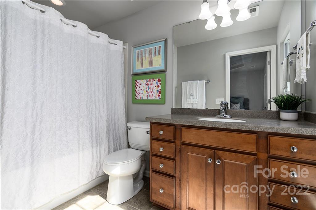 669 6th Baxter Crossing Fort Mill, SC 29708 - Photo 25 of 39 a bathroom with a sink a toilet and a mirror