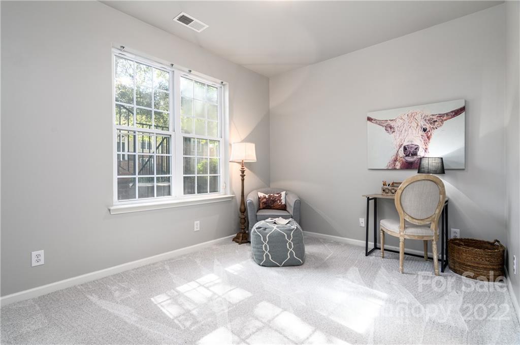 669 6th Baxter Crossing Fort Mill, SC 29708 - Photo 27 of 39 a room with a chair and large windows