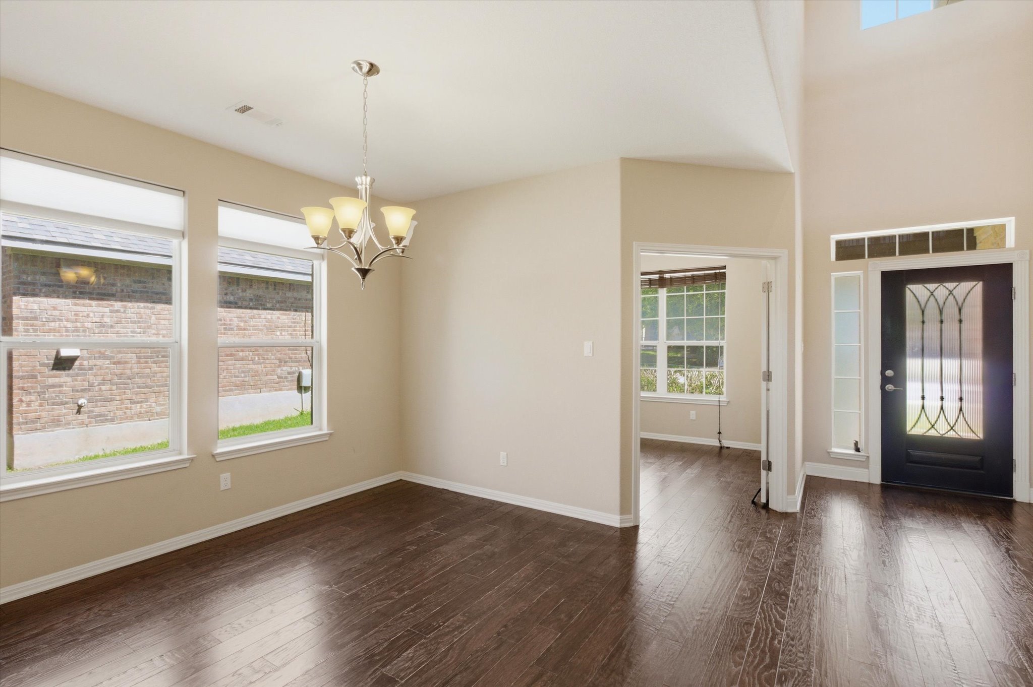 1511 Rimstone Drive Cedar Park, TX 78613 - Photo 5 of 39 Rich hardwood floors anchor this adaptable dining area, illuminated by a classic chandelier.