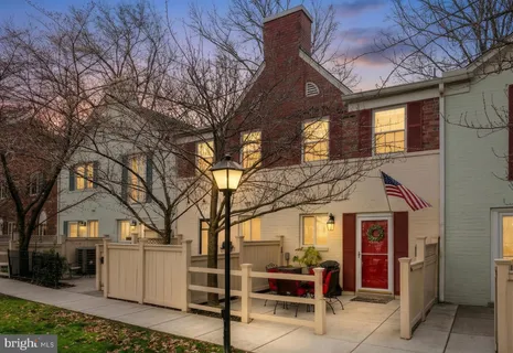 a view of a house with a chairs and table in a patio