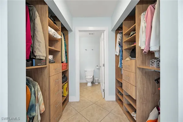 a bathroom with a toilet a sink a mirror and vanity