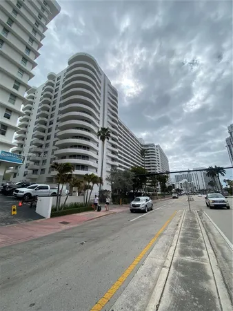 a front view of a multi story building with yard