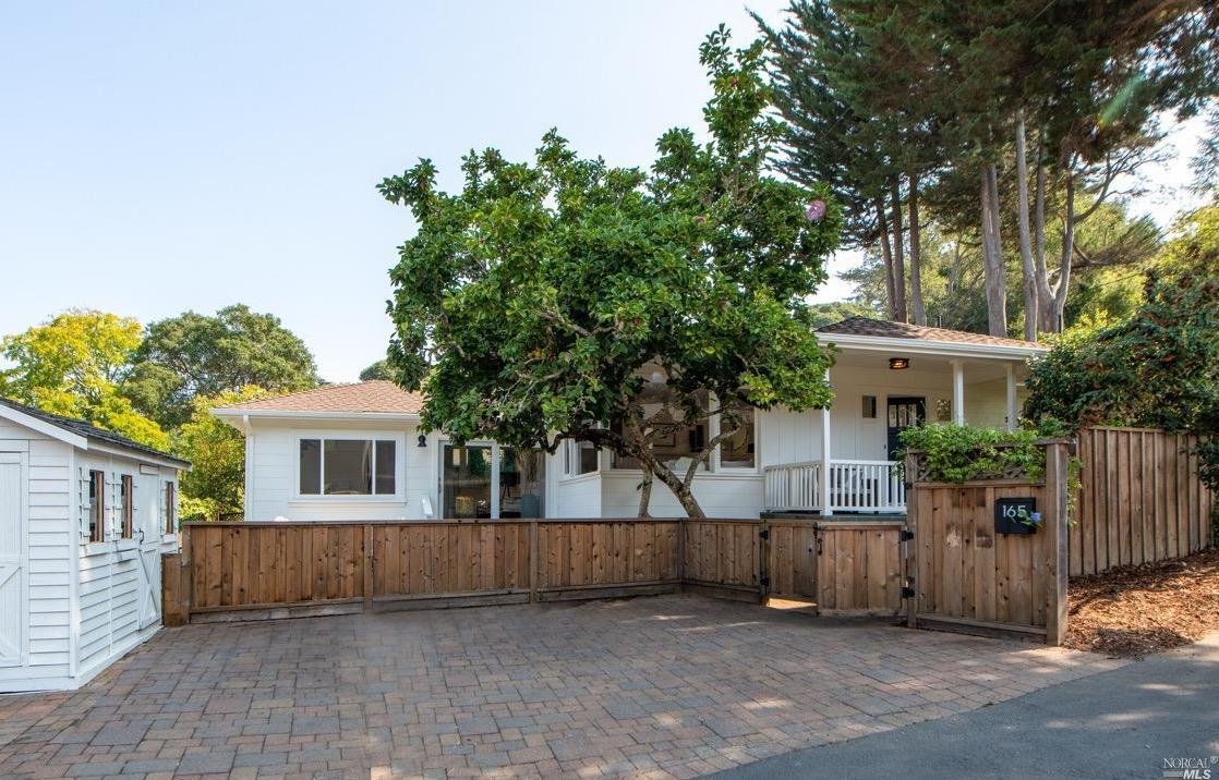 a view of house with outdoor space and a tree