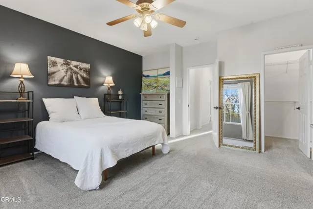 a spacious bedroom with a bed and a chandelier