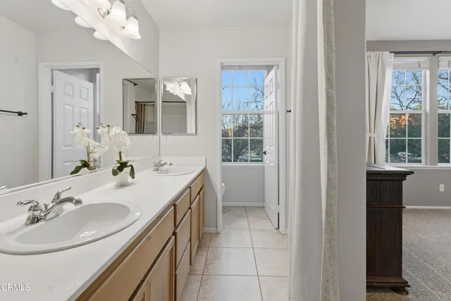 a bathroom with a sink double vanity and a mirror