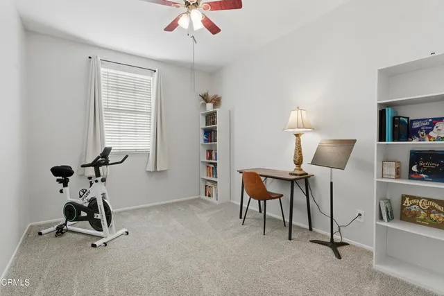 a view of a workspace with furniture and a window