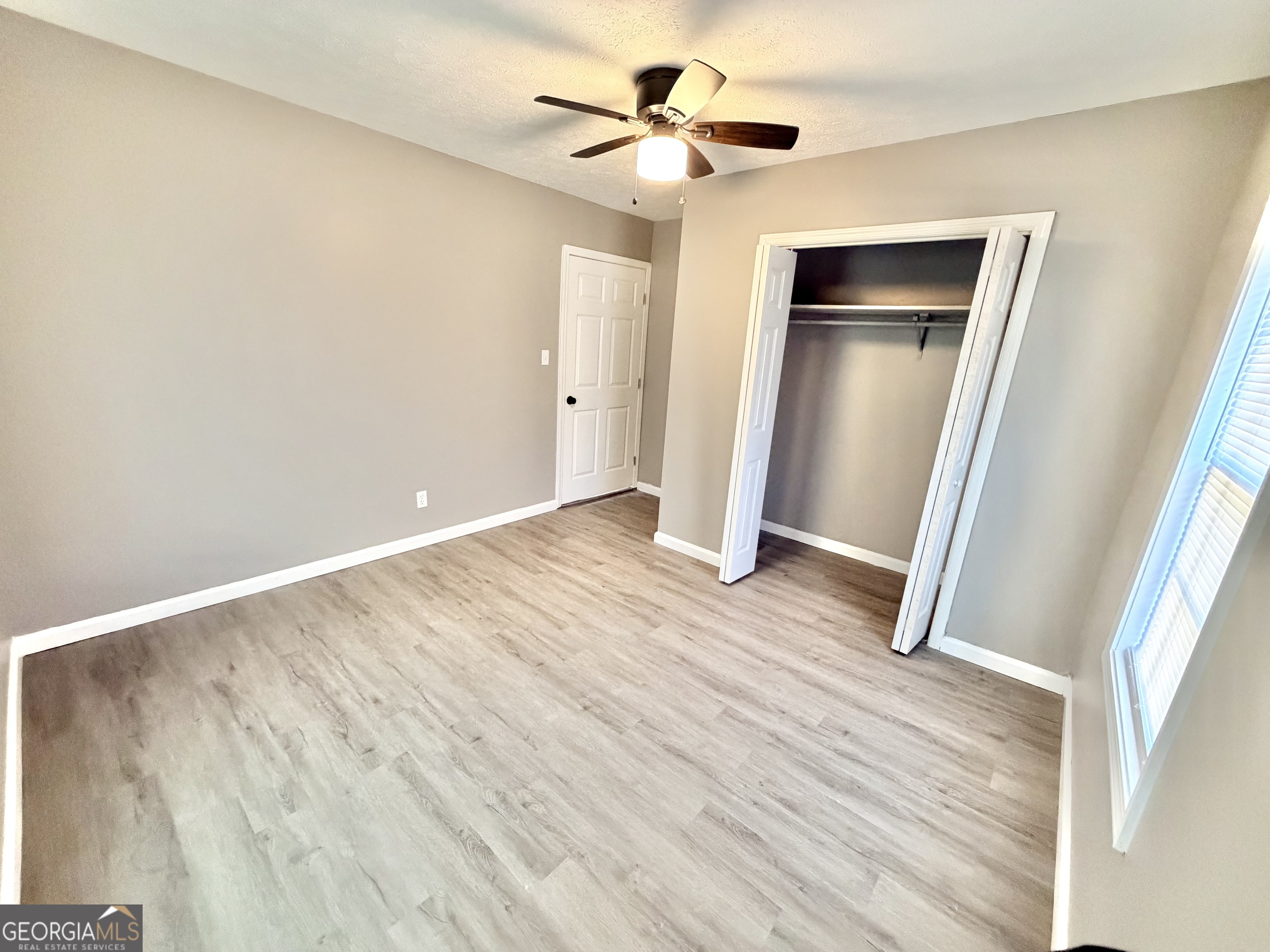 10 Busha Street Toccoa, GA 30577 - Photo 11 of 33 wooden floor in an empty room with a window