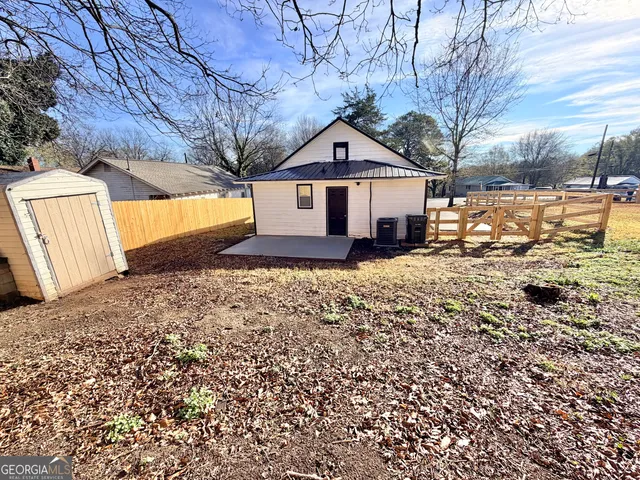 a front view of a house with a yard covered in snow