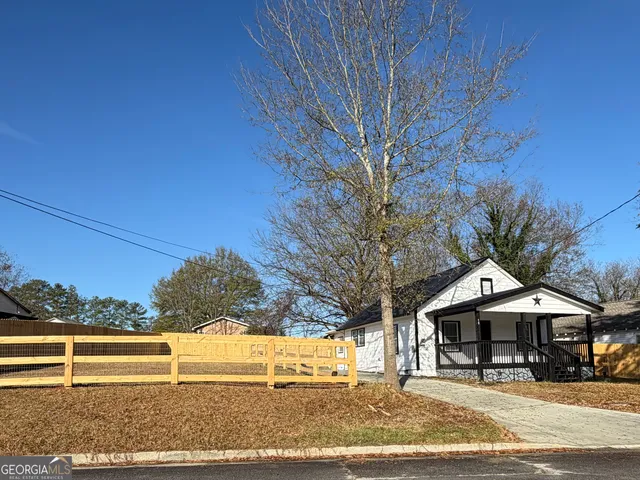 a front view of a building with trees