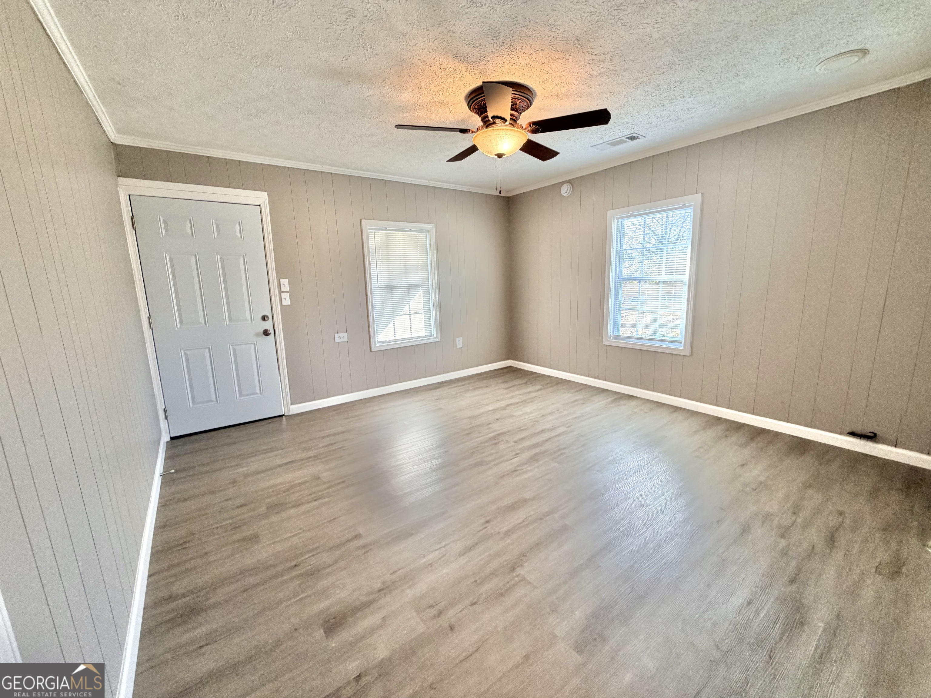 10 Busha Street Toccoa, GA 30577 - Photo 4 of 33 a view of an empty room with wooden floor and a window