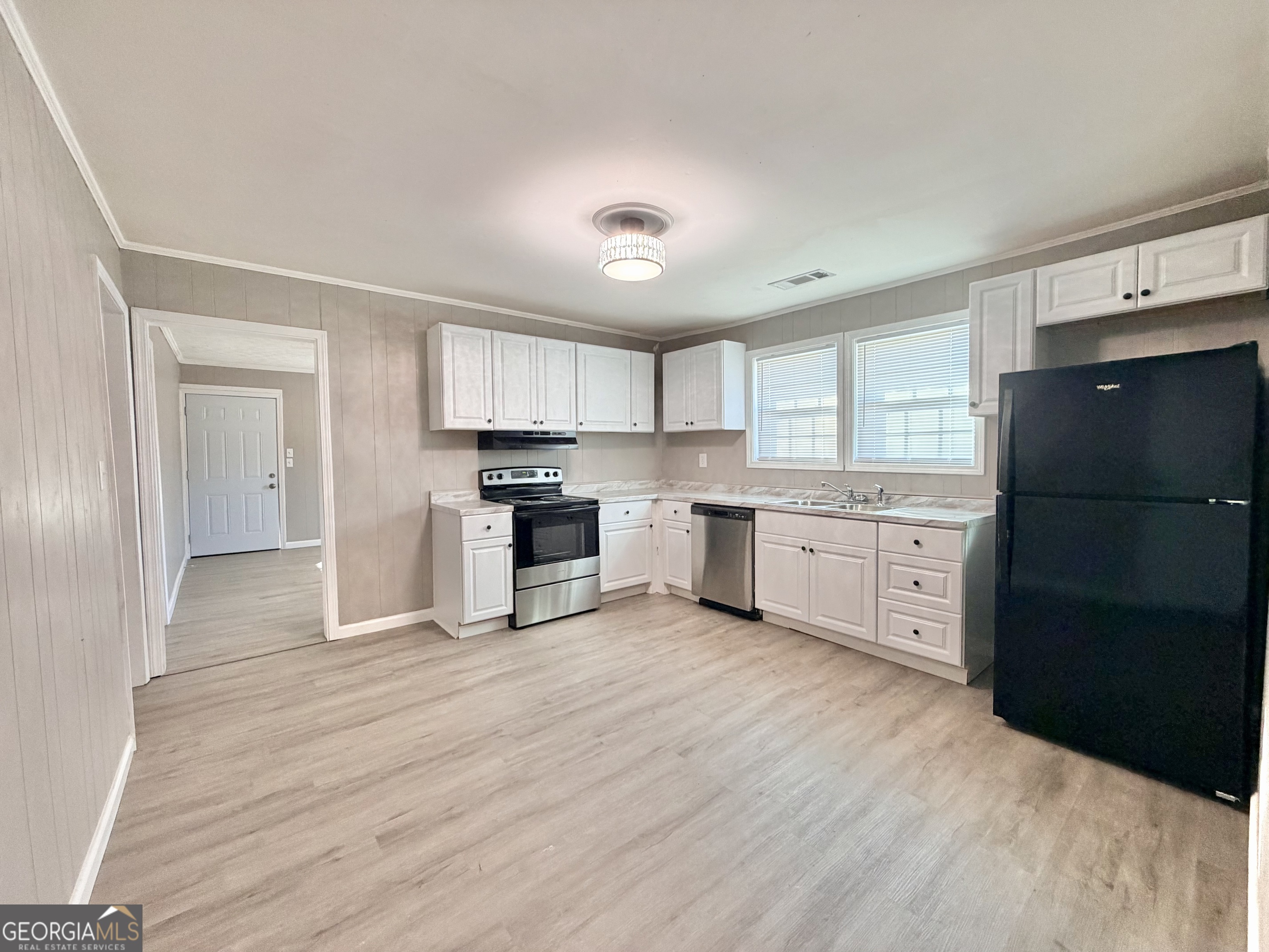 10 Busha Street Toccoa, GA 30577 - Photo 6 of 33 a kitchen with a refrigerator a sink and dishwasher with wooden floor