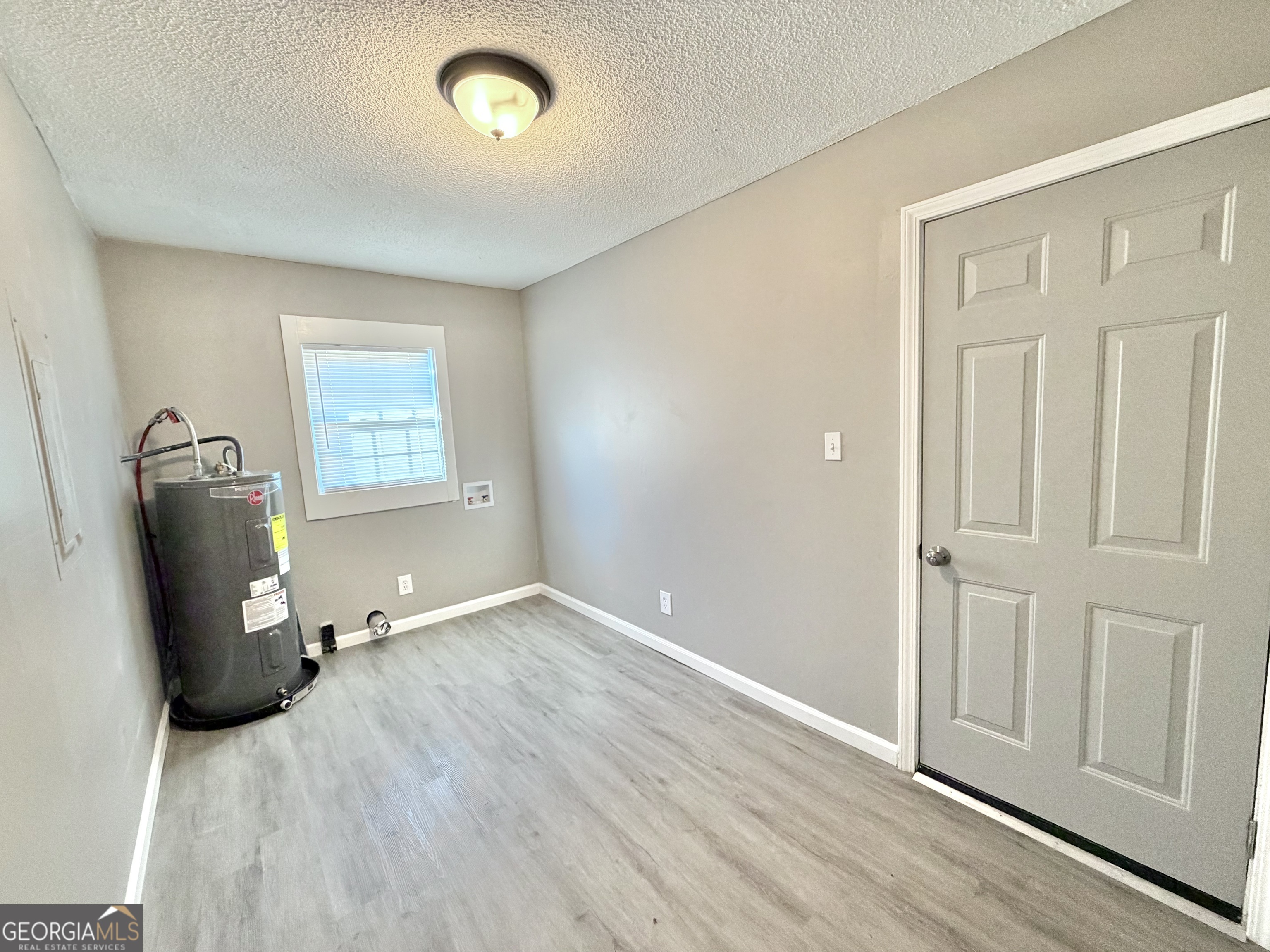 10 Busha Street Toccoa, GA 30577 - Photo 7 of 33 wooden floor in an empty room with a window