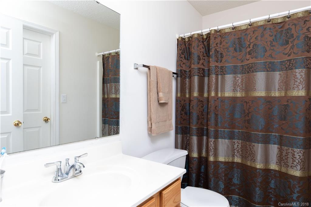 1007 Field Swallow Way, Unit 69 Clover, SC 29710 - Photo 11 of 18 a bathroom with a sink a toilet and shower