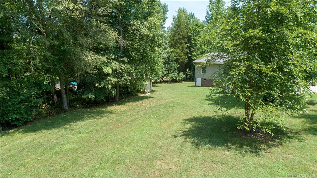1007 Field Swallow Way, Unit 69 Clover, SC 29710 - Photo 15 of 18 a backyard of a house with plants and large trees