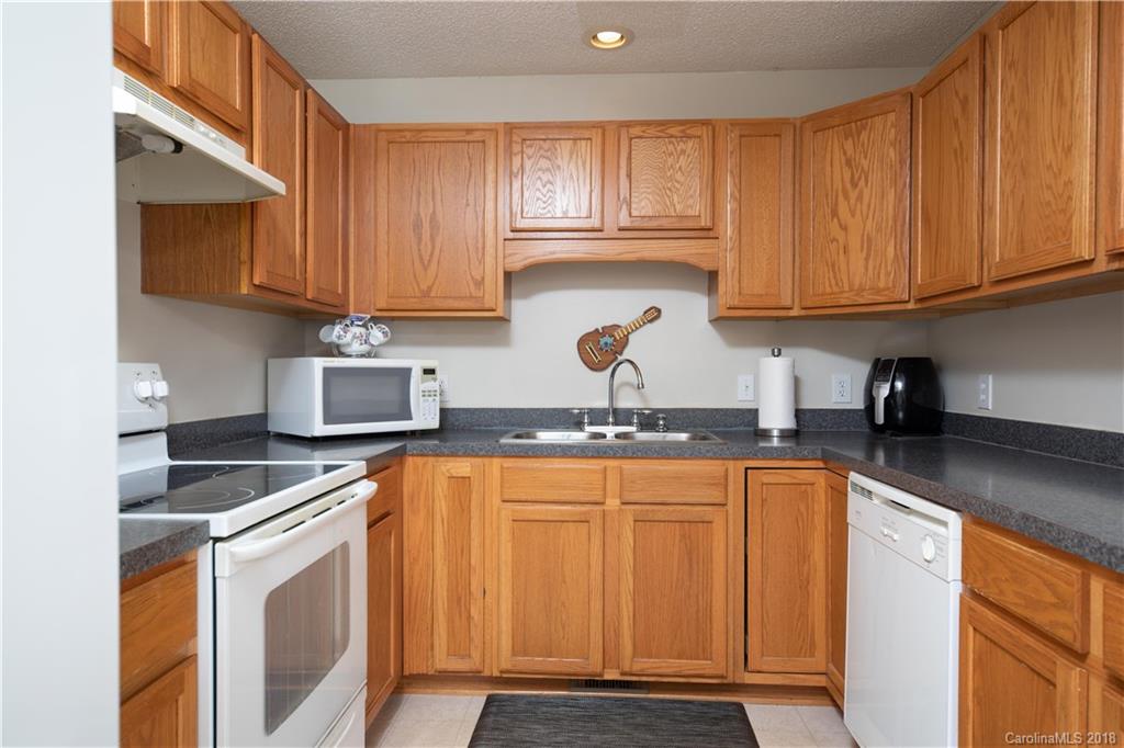 1007 Field Swallow Way, Unit 69 Clover, SC 29710 - Photo 6 of 18 a kitchen with stainless steel appliances granite countertop a sink stove and cabinets