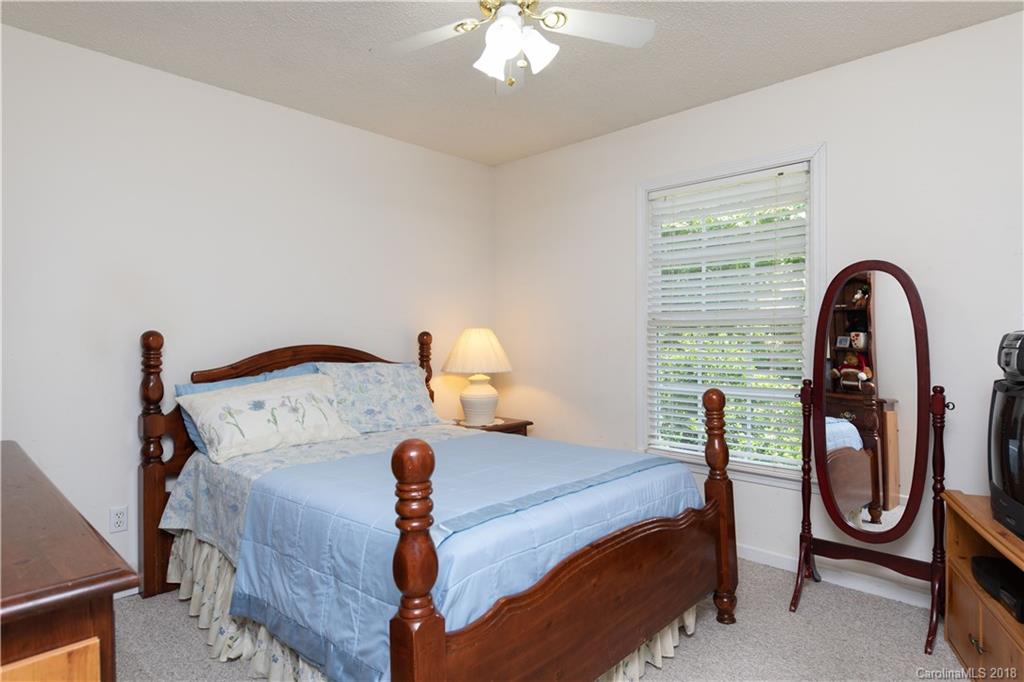 1007 Field Swallow Way, Unit 69 Clover, SC 29710 - Photo 8 of 18 a bedroom with a bed and a chandelier