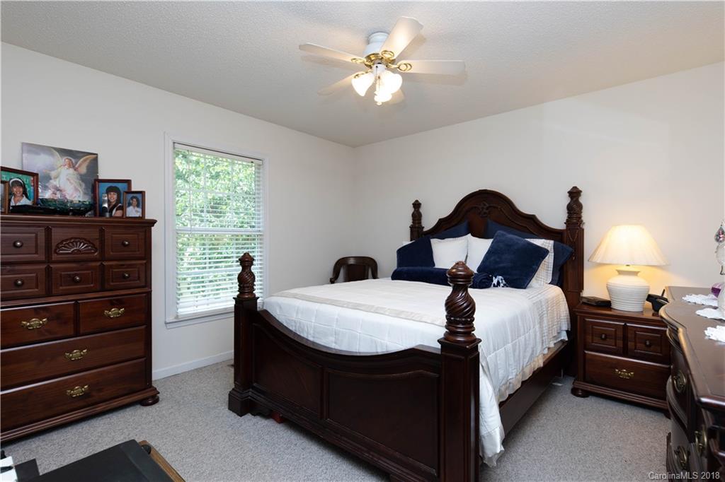 1007 Field Swallow Way, Unit 69 Clover, SC 29710 - Photo 9 of 18 a bedroom with a bed and a chandelier