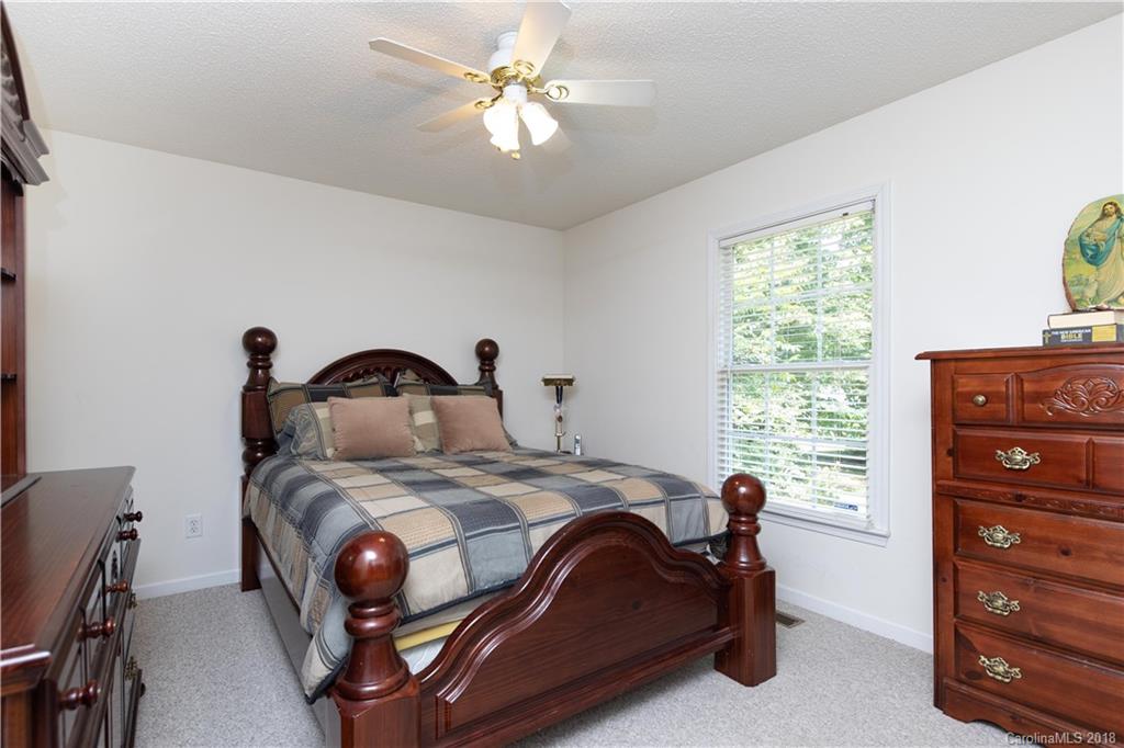 1007 Field Swallow Way, Unit 69 Clover, SC 29710 - Photo 10 of 18 a bedroom with a bed and a chandelier
